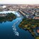 A dock crowded with boats in a waterway that runs through a city